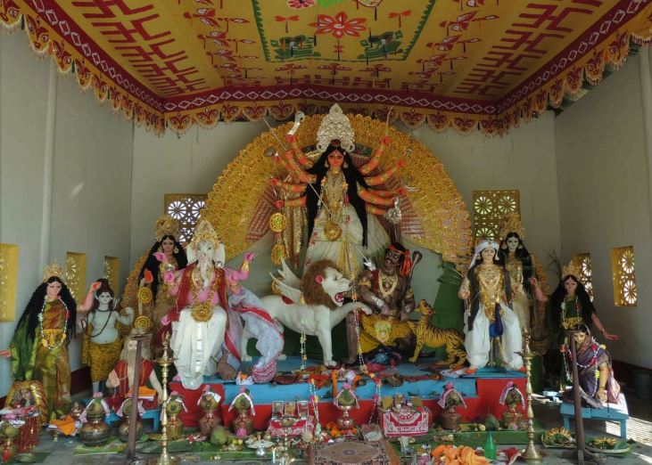 Traditional Rajbari-style Durga idol with the full family of deities at a Jalpaiguri Durga Puja